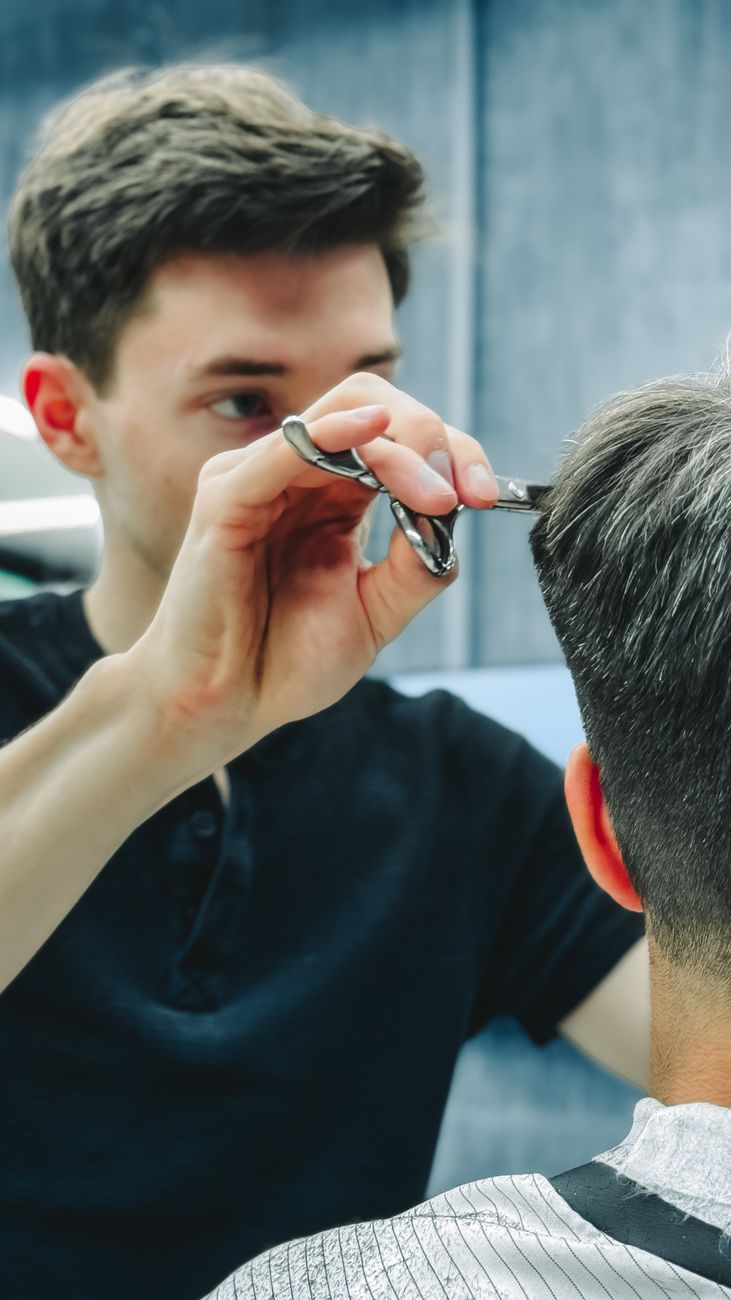 Gentleman receiving precision hair cut